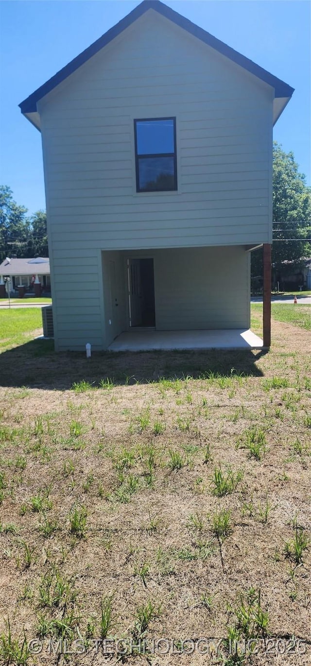 rear view of property with a lawn and a patio area