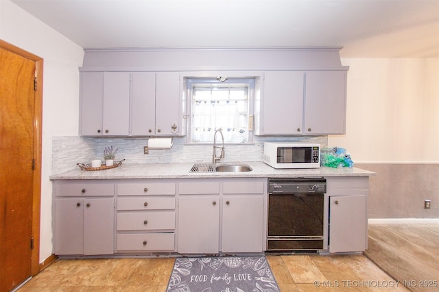 kitchen with sink, gray cabinetry, light stone counters, tasteful backsplash, and dishwasher