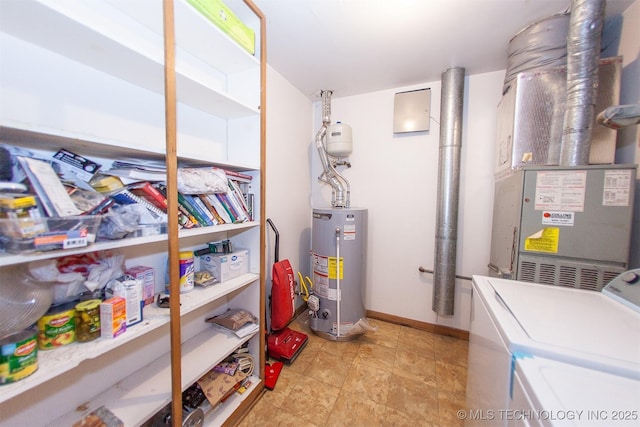 utility room featuring washer and dryer, water heater, and heating unit