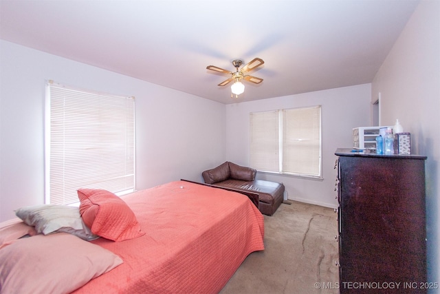 bedroom featuring light colored carpet and ceiling fan