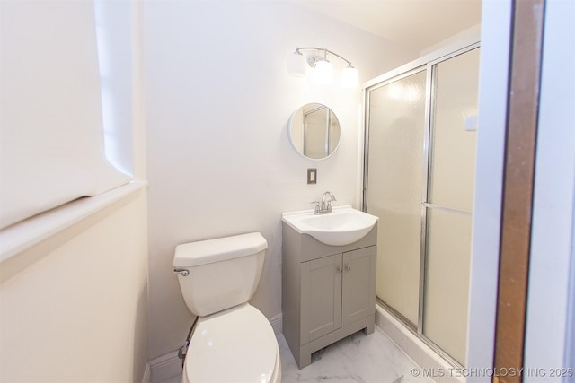 bathroom with vanity, a shower with shower door, and toilet