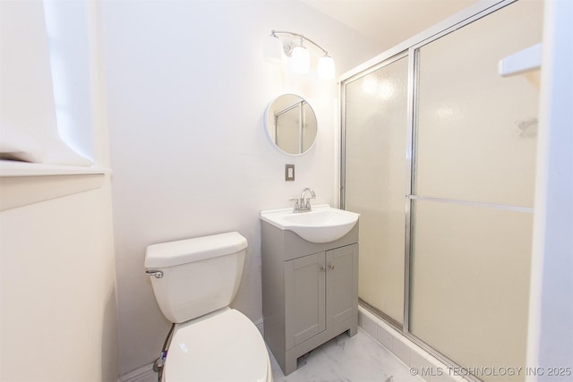 bathroom with vanity, a shower with shower door, and toilet