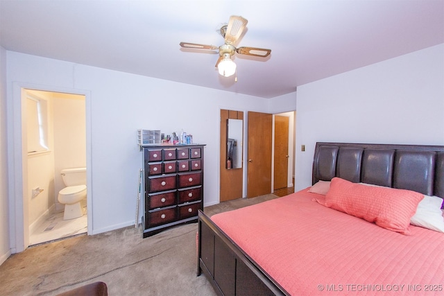 carpeted bedroom with connected bathroom and ceiling fan