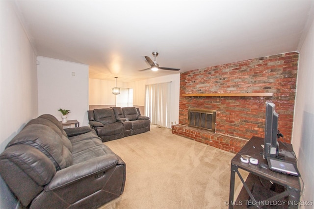 carpeted living room featuring a brick fireplace and ceiling fan