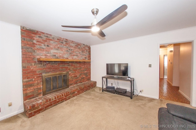 living room with crown molding, a brick fireplace, light colored carpet, and ceiling fan