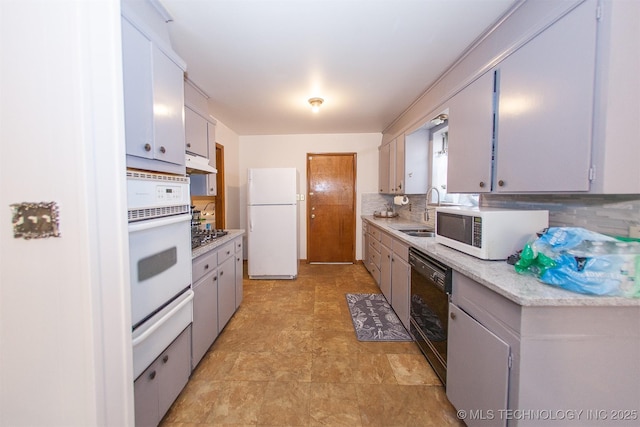 kitchen with sink, white appliances, and backsplash