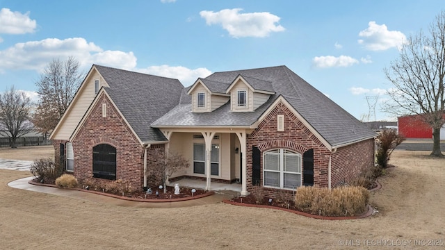 view of front of property featuring covered porch and a front yard