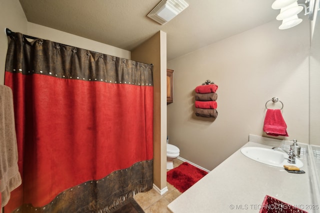 bathroom featuring tile patterned flooring, vanity, and toilet