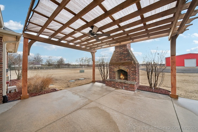 view of patio featuring an outdoor brick fireplace and a pergola