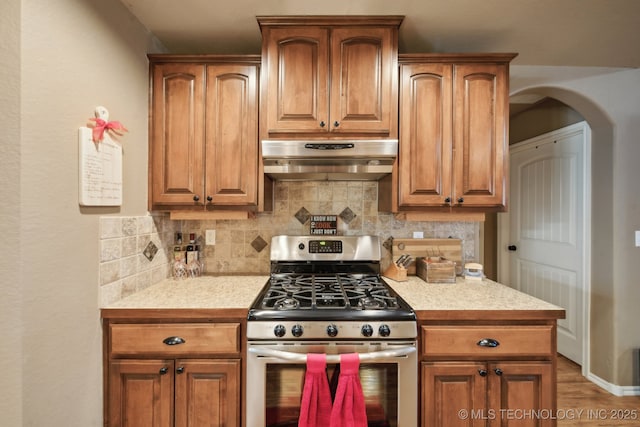 kitchen featuring tasteful backsplash and gas stove