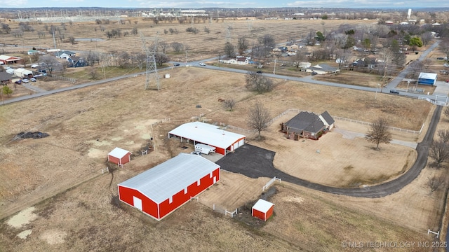 birds eye view of property with a rural view