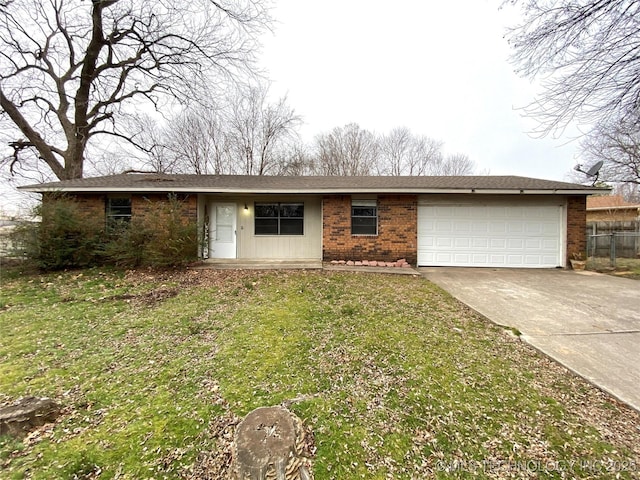 single story home featuring a garage and a front lawn