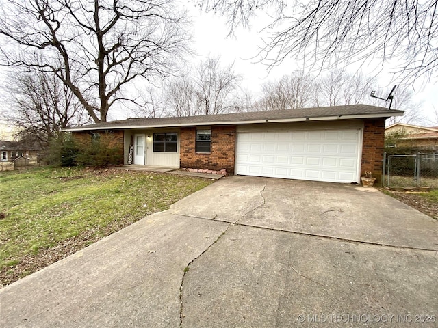 ranch-style home with a front lawn and a garage