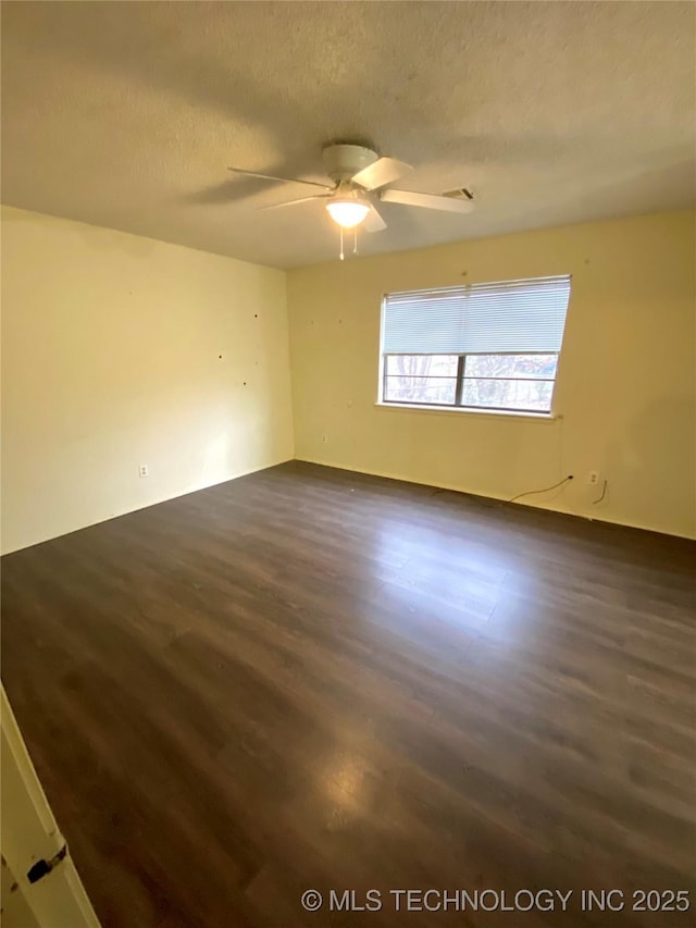 unfurnished room featuring ceiling fan, a textured ceiling, and dark hardwood / wood-style flooring