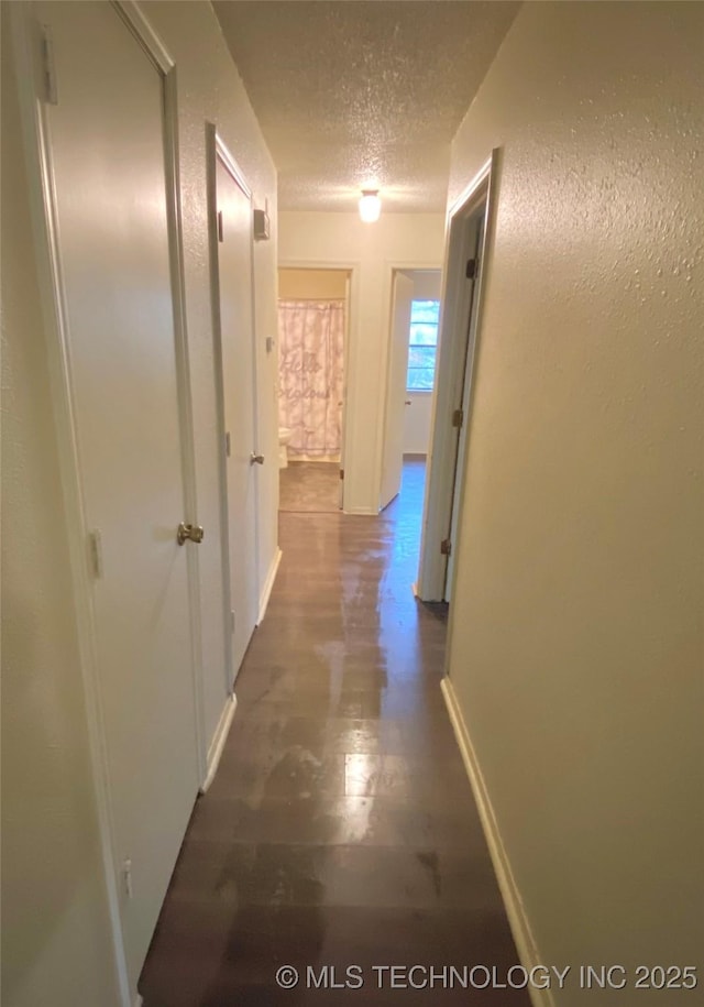 corridor featuring a textured ceiling