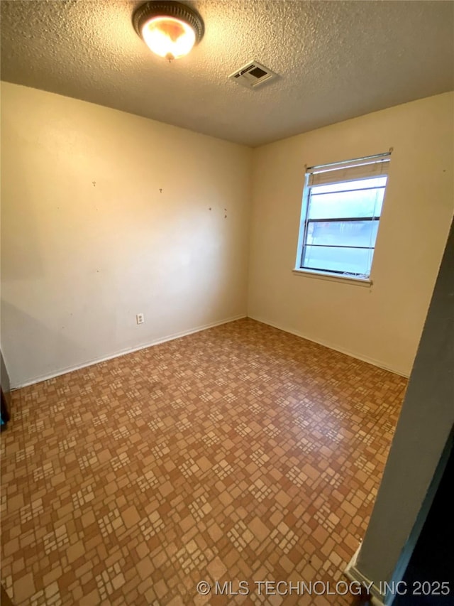 empty room with a textured ceiling