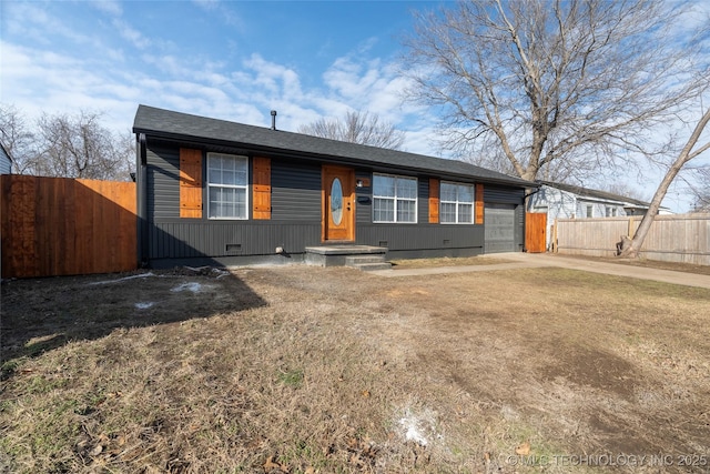 ranch-style house with a garage and a front lawn