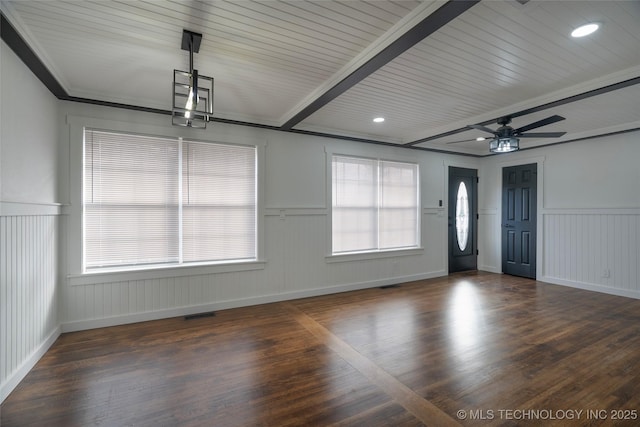 unfurnished room featuring beamed ceiling, dark hardwood / wood-style flooring, ceiling fan, wood ceiling, and crown molding