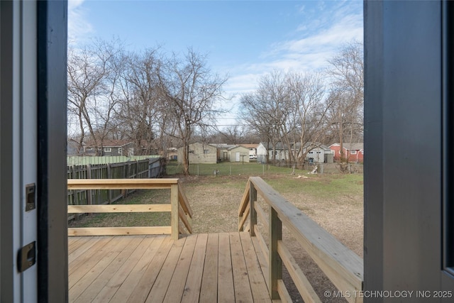 wooden deck featuring a lawn