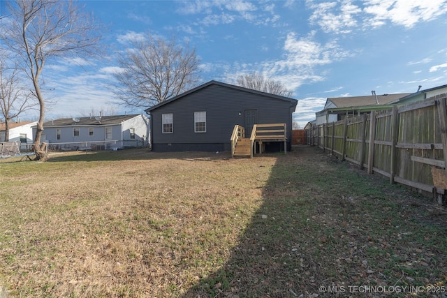 rear view of property with a yard