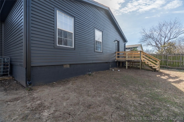 view of home's exterior featuring a wooden deck and central air condition unit