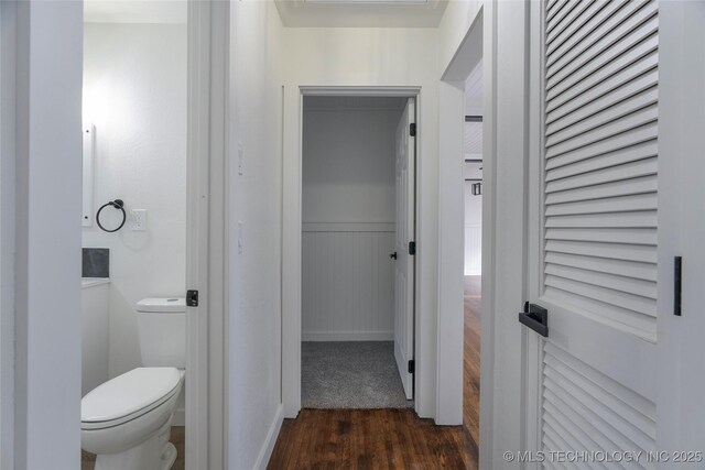 bathroom with hardwood / wood-style floors and toilet