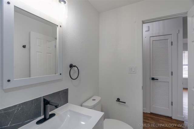 bathroom featuring sink, hardwood / wood-style flooring, and toilet