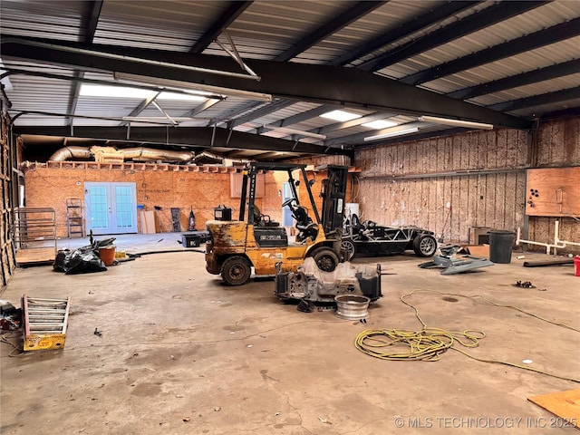 garage featuring wood walls