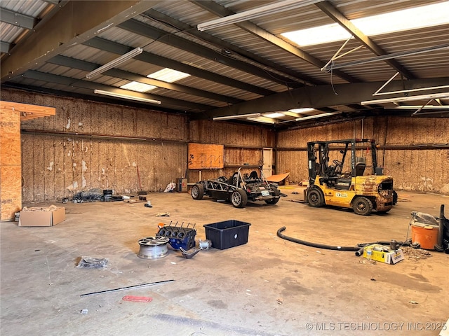 garage featuring wood walls