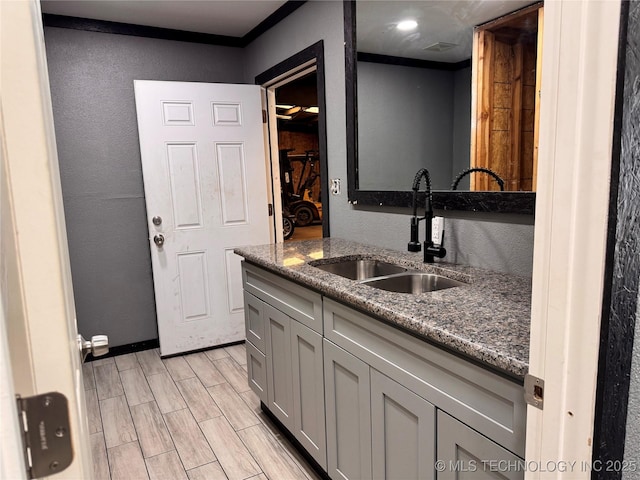 kitchen featuring sink and dark stone countertops