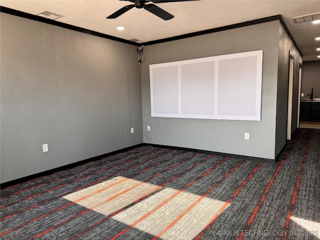 spare room featuring dark colored carpet, crown molding, and ceiling fan