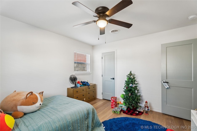 bedroom with ceiling fan and light hardwood / wood-style flooring