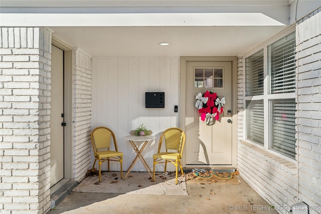 view of exterior entry featuring electric panel