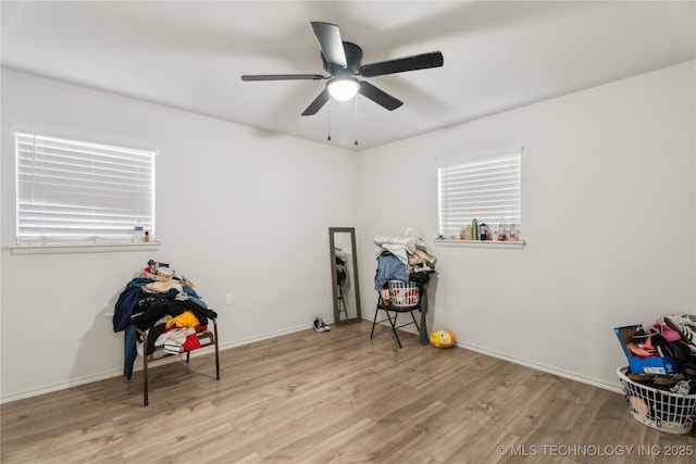 miscellaneous room featuring ceiling fan and light hardwood / wood-style flooring