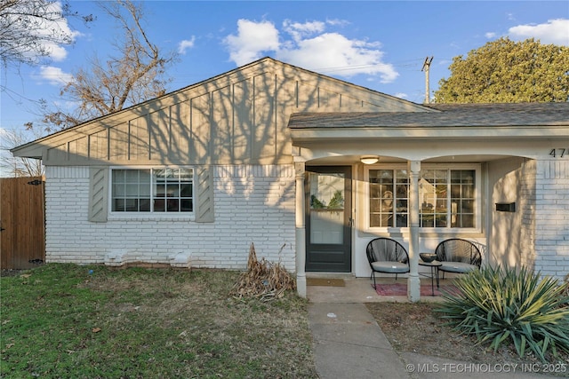 doorway to property with a lawn