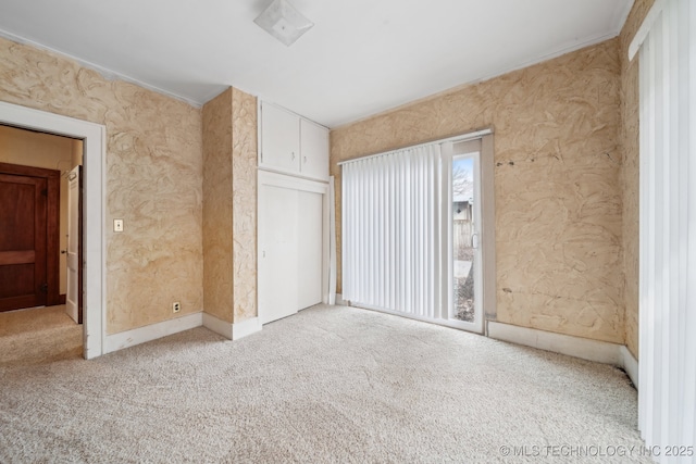 unfurnished bedroom featuring multiple windows and light carpet