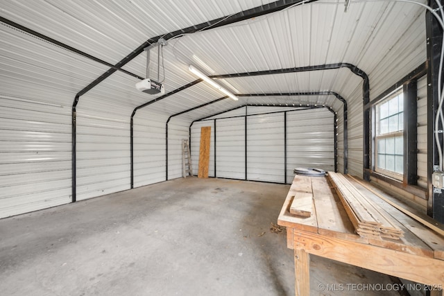 garage with a garage door opener and a carport