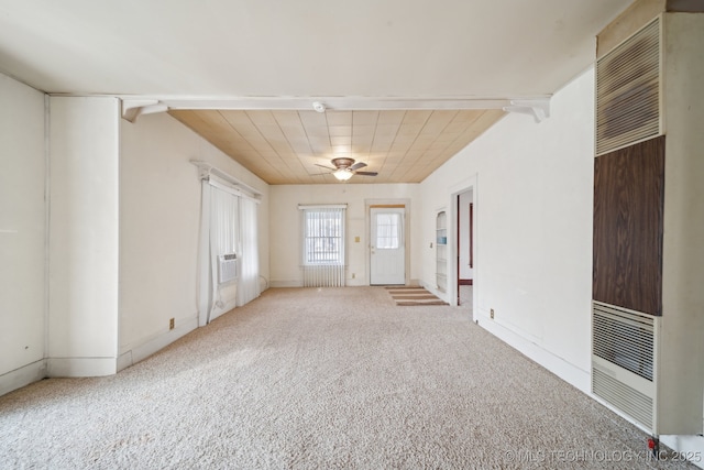 carpeted spare room featuring ceiling fan and lofted ceiling with beams