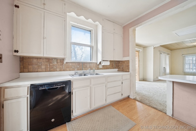 kitchen featuring dishwasher, white cabinetry, tasteful backsplash, sink, and light hardwood / wood-style flooring