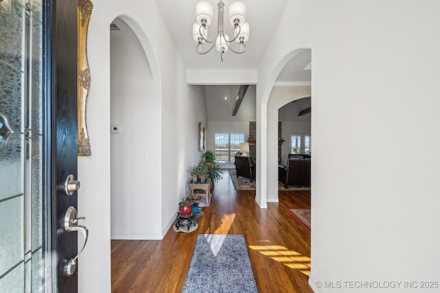 entrance foyer featuring dark hardwood / wood-style floors and a chandelier