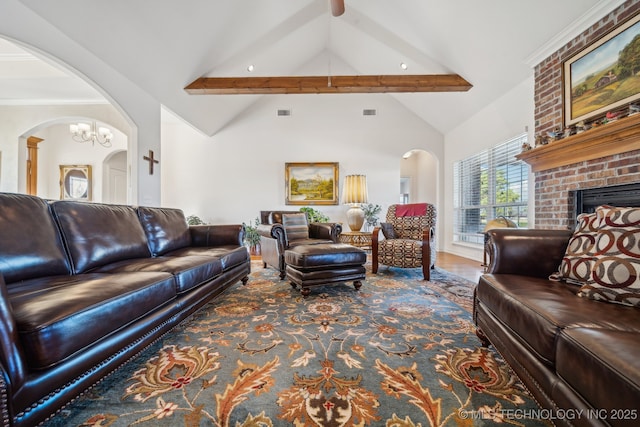 living room featuring high vaulted ceiling, beam ceiling, a chandelier, and a fireplace