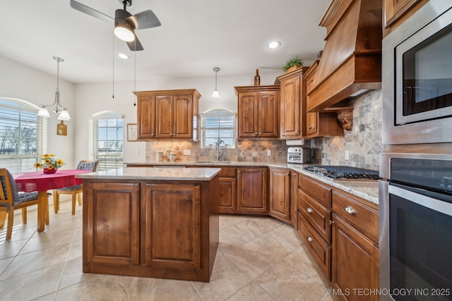 kitchen with premium range hood, backsplash, a center island, and stainless steel appliances