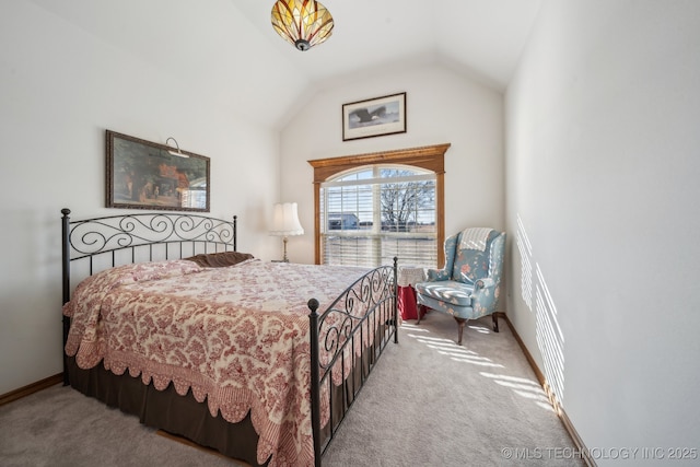 bedroom featuring light colored carpet and lofted ceiling