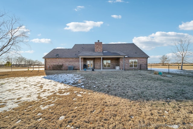 back of house featuring a lawn and a patio area