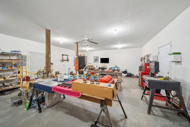 garage with ceiling fan and a workshop area