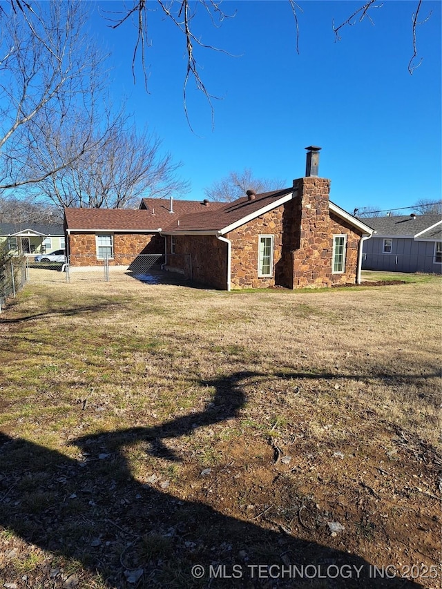 rear view of property with a lawn