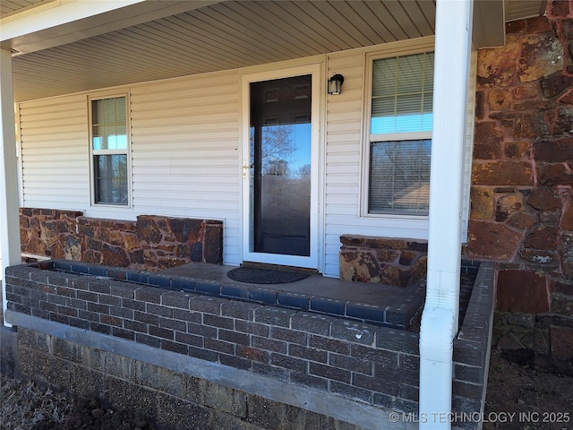 view of exterior entry with a porch