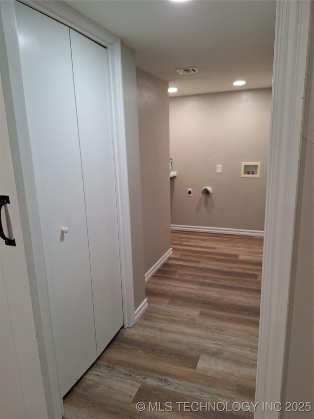 washroom featuring hardwood / wood-style flooring, washer hookup, and hookup for a gas dryer