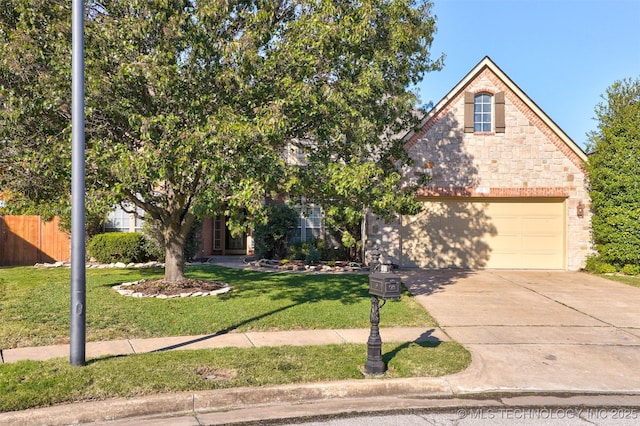 view of property hidden behind natural elements with a front lawn and a garage