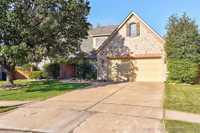 front facade featuring a front lawn and a garage